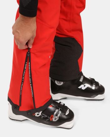 Pánské lyžařské kalhoty Kilpi METHONE-M černá 5XL: detail rozepínání nohavice na lyžáku s rukou. (5)
